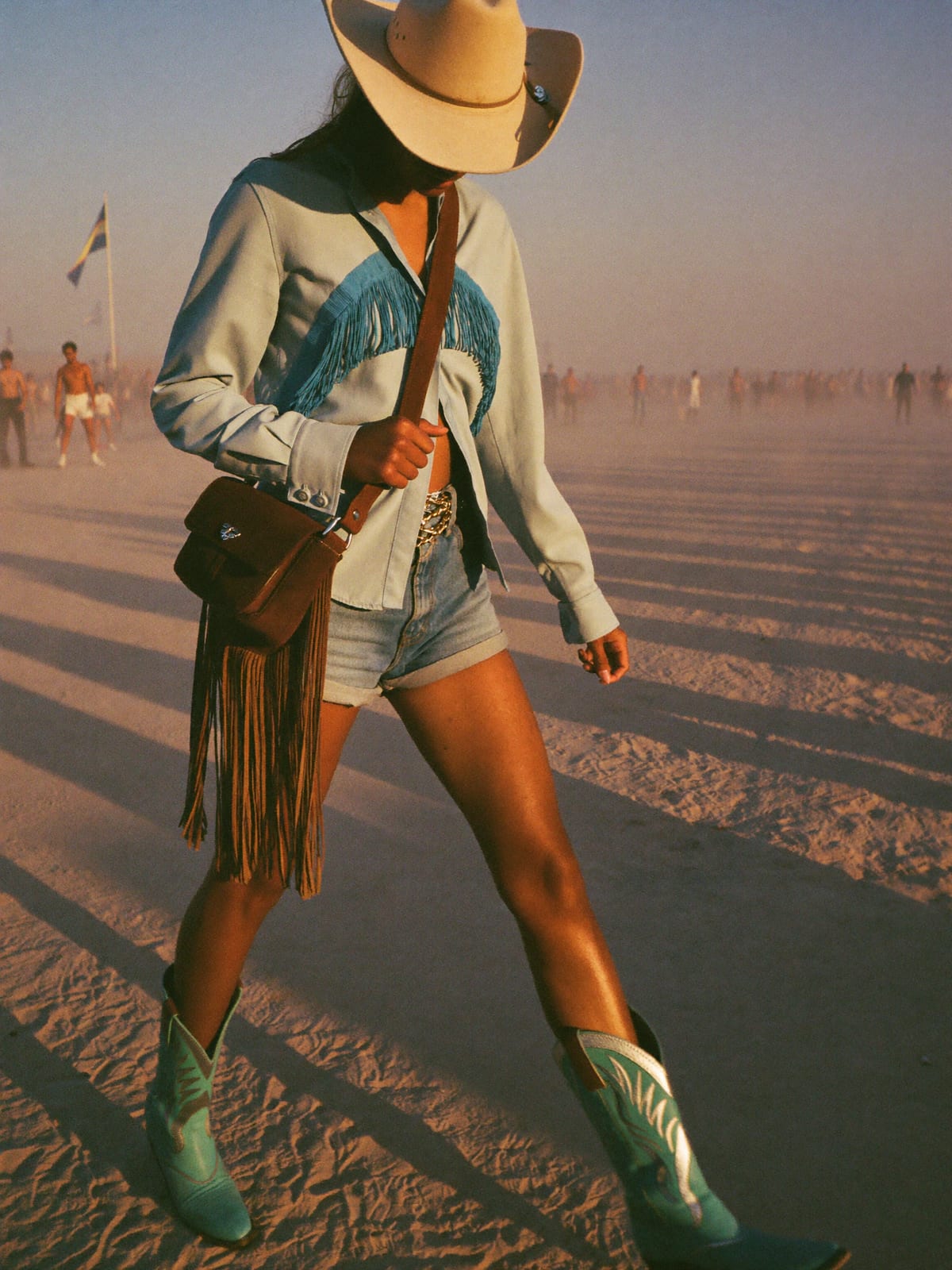 Cowboy Core outfit for Burning Man: straw or felt cowboy hat, western shirt or fringed top, denim shorts or straight jeans