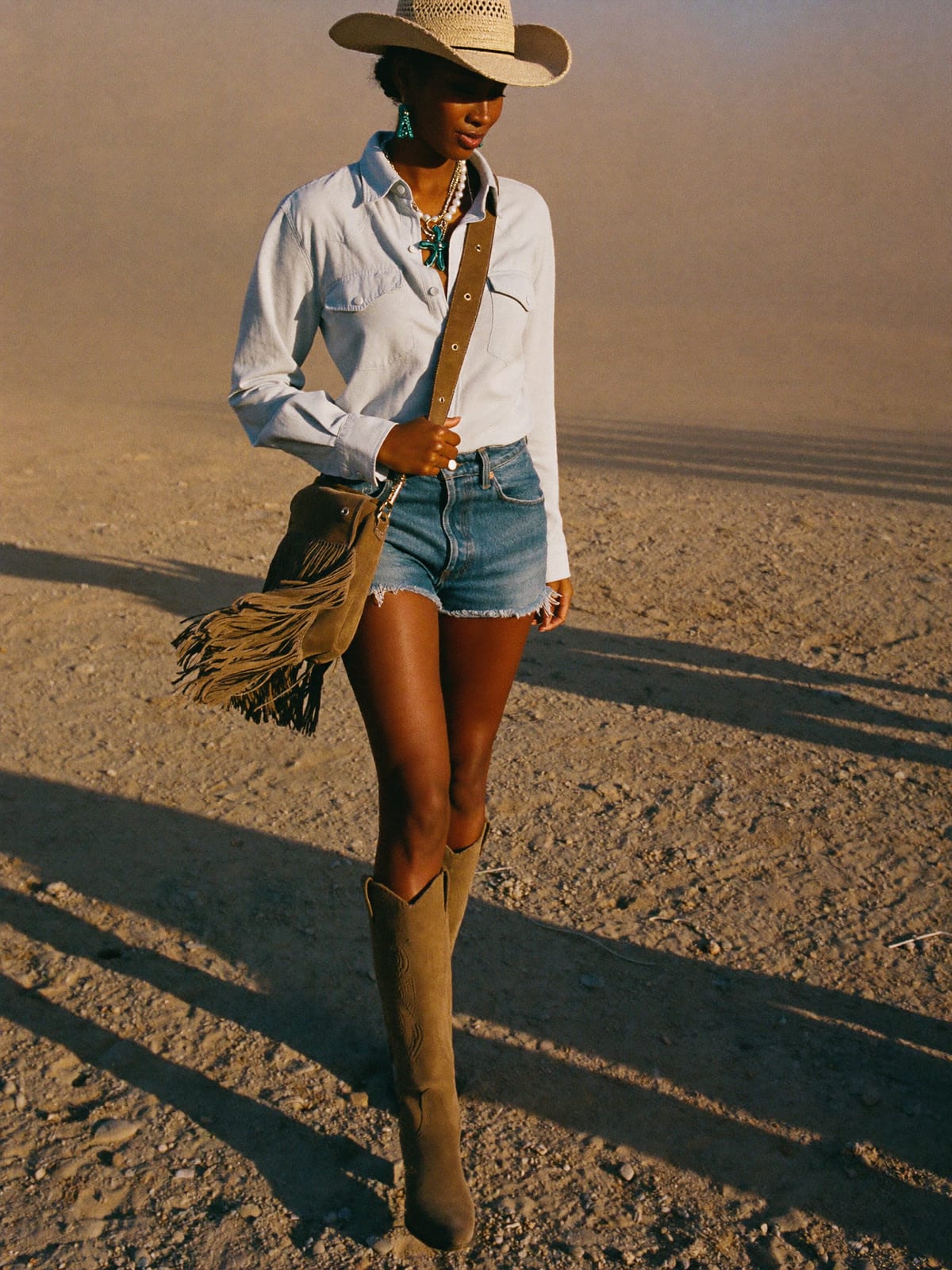 Cowboy Core outfit for Coachella: straw or felt cowboy hat, western shirt or fringed top, denim shorts or straight jeans