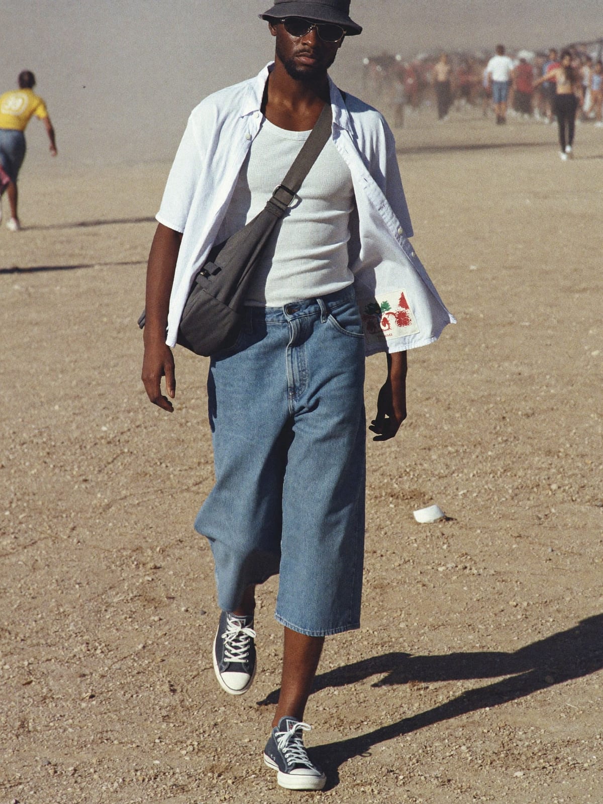 Jorts & Tank outfit for Coachella: denim jorts, ribbed tank or open camp shirt, canvas or retro runners