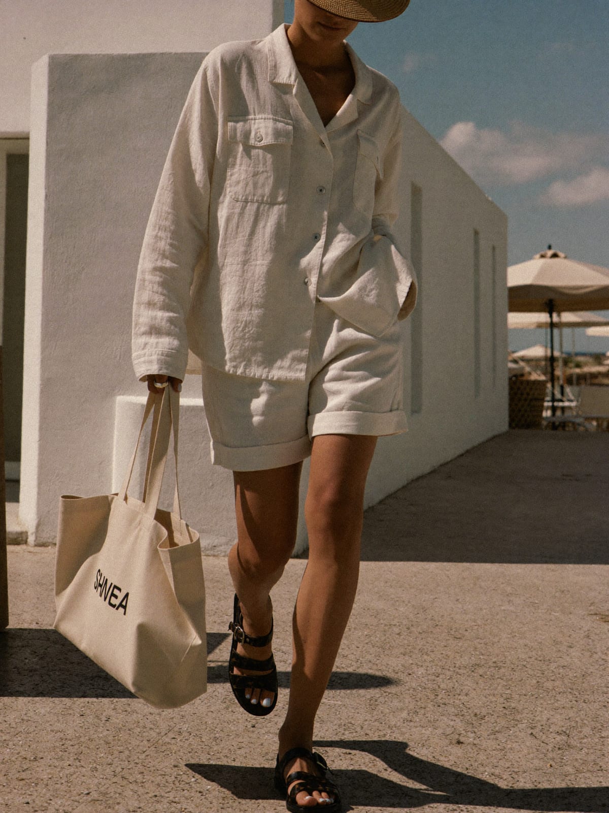 Linen Minimal outfit for Ibiza Opening Parties: linen camp-collar shirt, tailored linen shorts, leather sandals