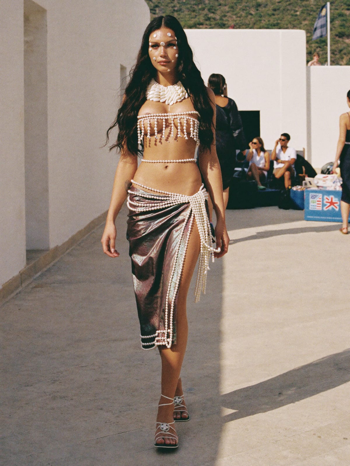 Mermaidcore outfit for Ibiza Opening Parties: shell or pearl-trim top, iridescent sarong or skirt, strappy flat sandals