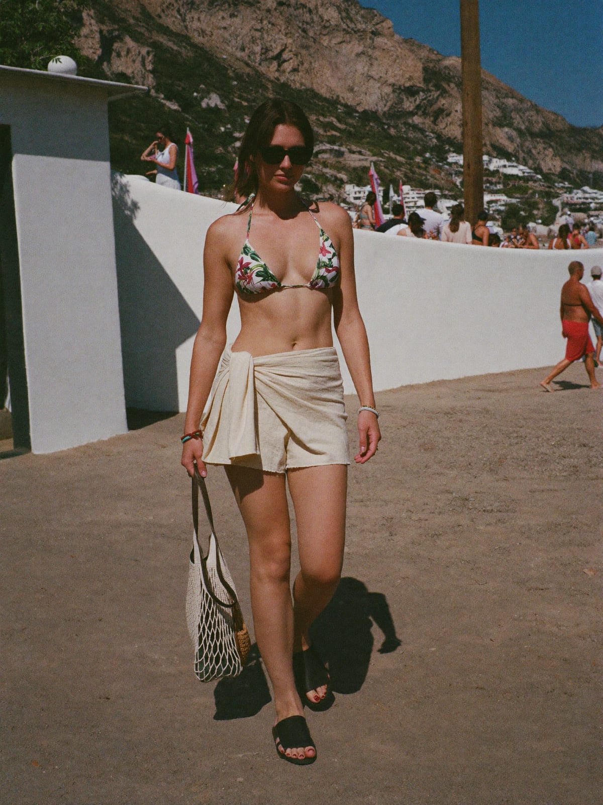 Tropical Beach outfit for Ibiza Opening Parties: bikini or triangle top, sarong or linen shorts, flat sandals or slides