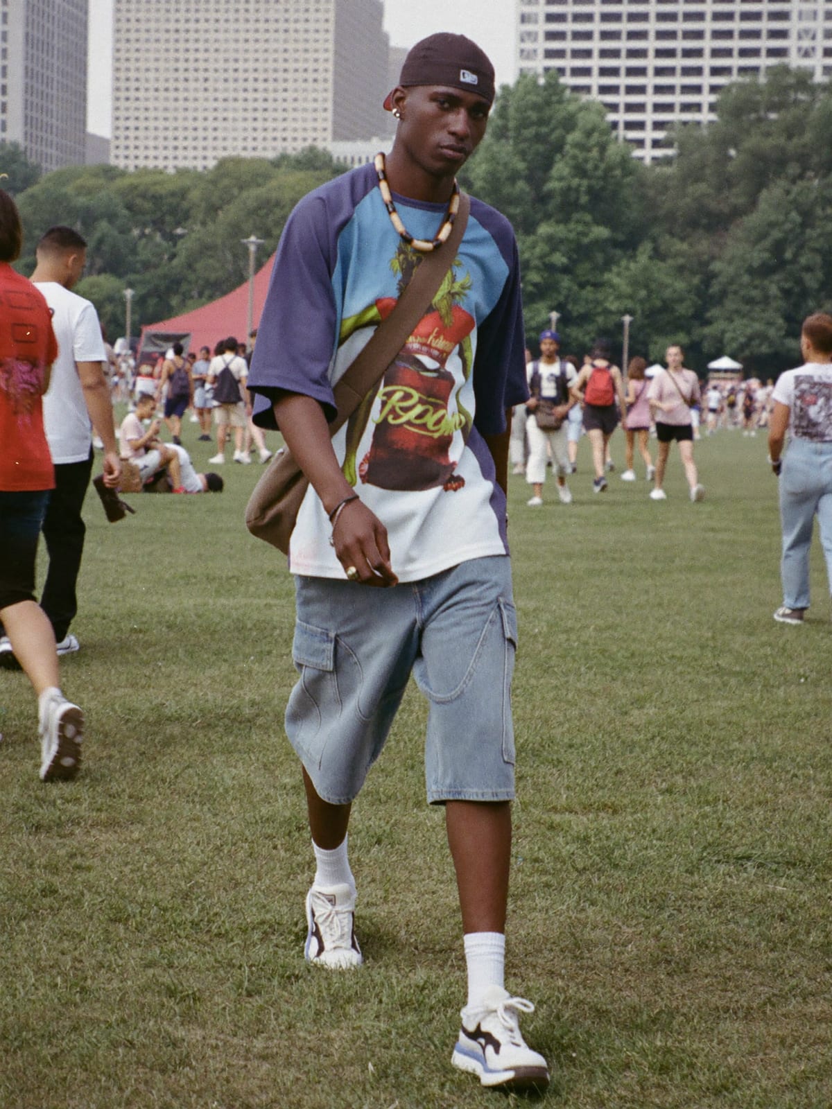 Street Heat outfit for Lollapalooza: oversized graphic tee or jersey, baggy denim or cargo shorts, statement sneakers