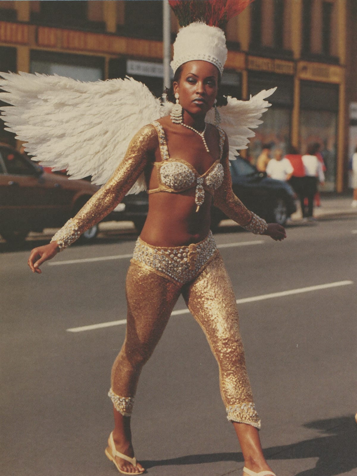Carnival Feathers outfit for Mardi Gras New Orleans: feather headpiece and wings, sequin bodysuit, body gems and glitter