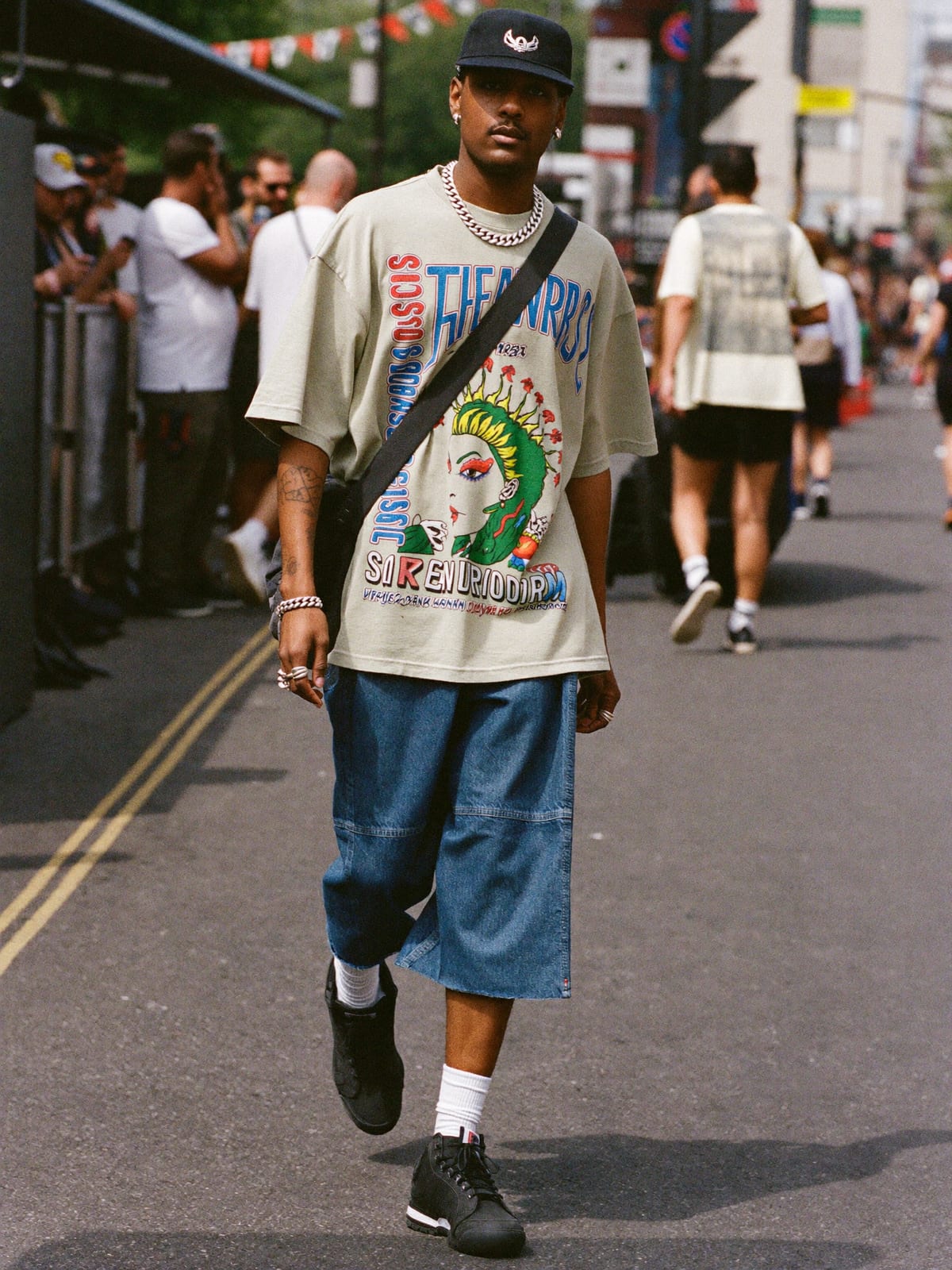 Street Heat outfit for Notting Hill Carnival: oversized graphic tee or jersey, baggy denim or cargo shorts, statement sneakers