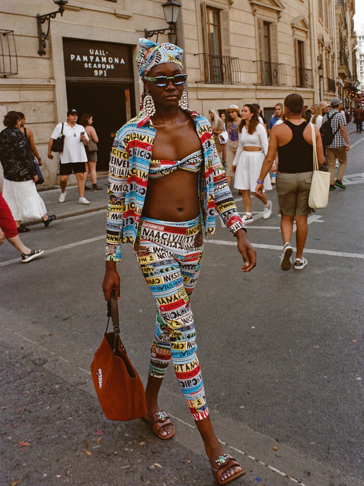 Afro Print Statement outfit for San Fermín: printed co-ord set, open shirt or wrap top, leather sandals or slides