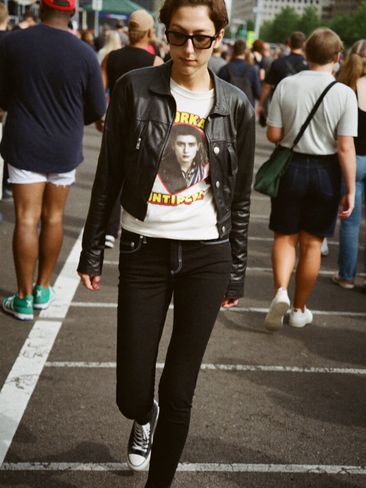 Indie Sleaze outfit for Summerfest: cropped leather jacket, vintage band or slogan tee, skinny or straight black jeans