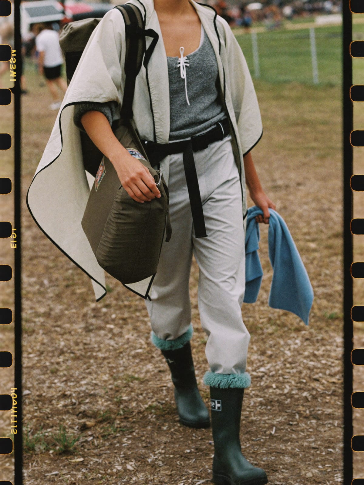 Mud-Proof Practical outfit for Tomorrowland: waterproof poncho, wellington boots with thick socks, fleece mid-layer